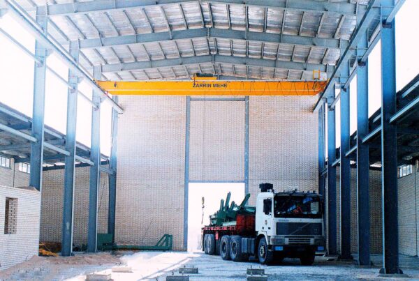 Overhead Crane Performing Heavy-Duty Lifting Tasks in Industrial Facility