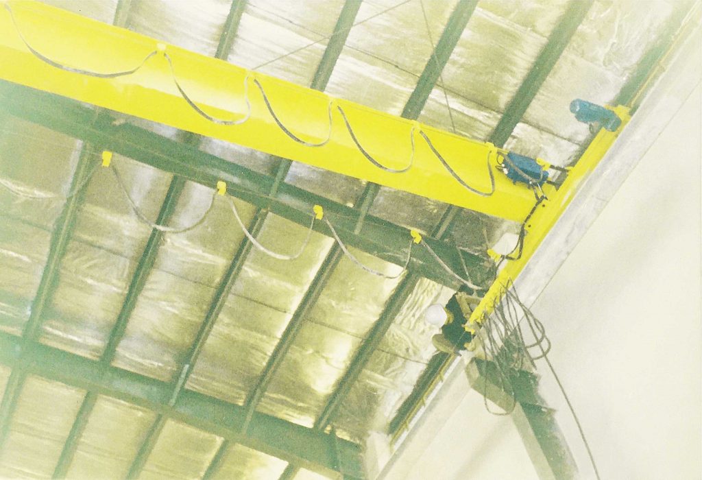 Overhead Crane Performing Heavy-Duty Lifting Tasks in Industrial Facility